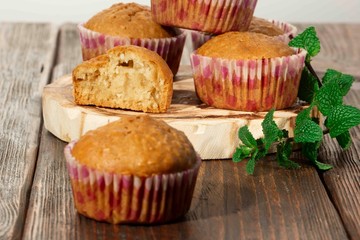 Vanilla cupcake, homemade pastry on wooden background