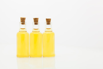Essence of flowers on white background in beautiful glass Bottle