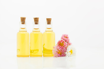 Essence of flowers on table in beautiful glass jar