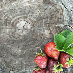 ripe strawberries on a wooden background. old wood texture