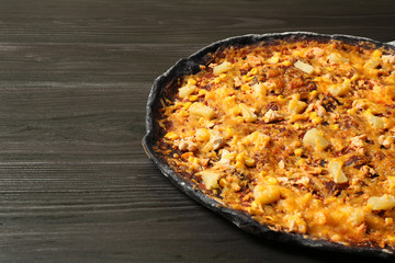 Black pizza on wooden table, closeup. Space for text