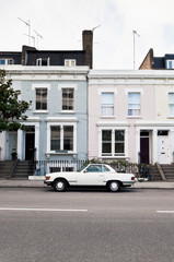Street in West London with typical Victorian houses and vintage car