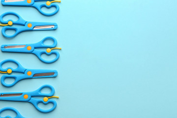 Set of training scissors on color background, flat lay. Space for text