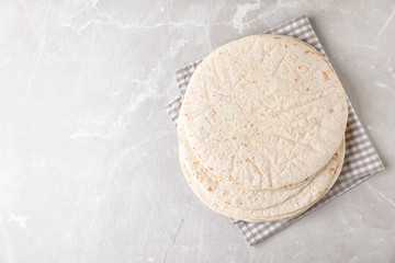 Corn tortillas on light background, top view with space for text. Unleavened bread