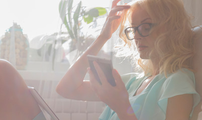 young woman looking through window
