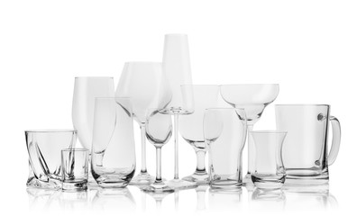 Set of empty glasses for different drinks on white background