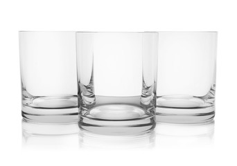 Empty clear lowball glasses on white background