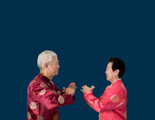 Asian senior couple celebrate Chinese new year in red traditional costume