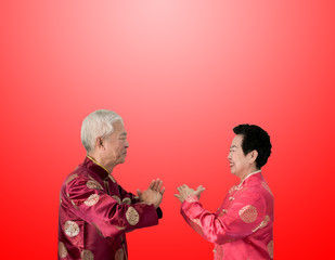 Asian senior couple celebrate Chinese new year in red traditional costume