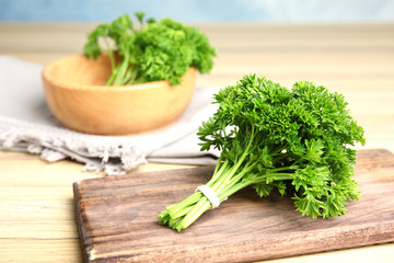 Fresh green parsley on wooden table, space for text