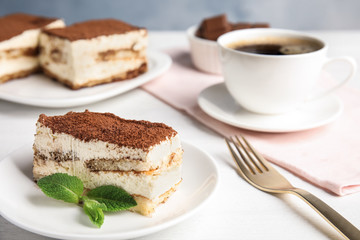 Tiramisu cake and drink served on table