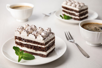Composition with tiramisu cake and mint on table