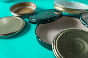 Recycling glass jar lids for reuse of single use items; Zero no waste recycle program campaigns; Recyclable concept on blank empty copyspace, text room space for copy on horizontal cyan background.
