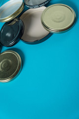 Recycling glass jar lids; Reuse of single use items; Zero no waste recycle program campaigns; Recyclable concept on blank empty copyspace, text room space for copy on vertical light blue background.