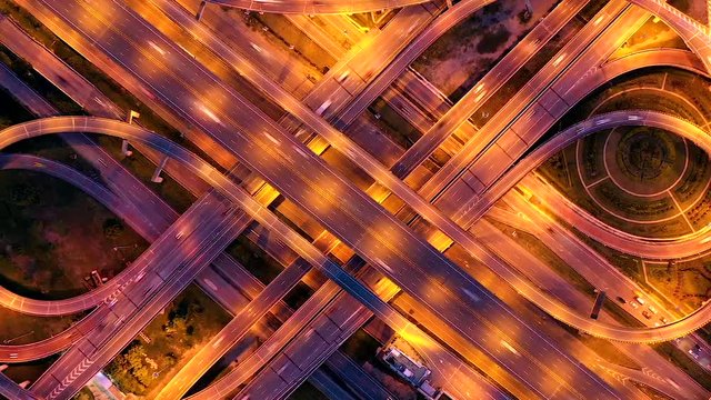 Aerial view of highway at rush hour at night time with car trail and traffic. view from drone