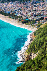 Fototapeta premium Beautiful top view of the resort city on the turquoise sea. Vertical.