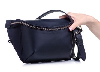 Black leather waist bag in hand on white background isolation