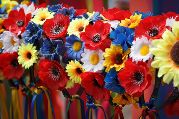 Different decorative artificial flowers colorful closeup