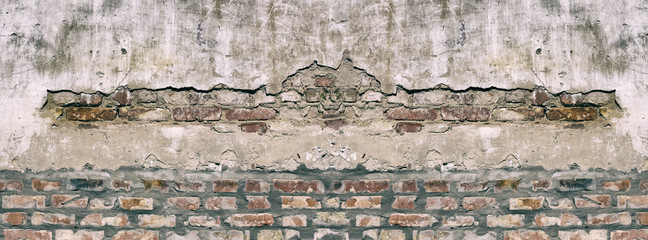 Panorama old damaged brick wall with shabby plaster.