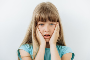 Surprised,shock ,unbelievable emotion. 9 year girl face portrait agaist white backgraund.