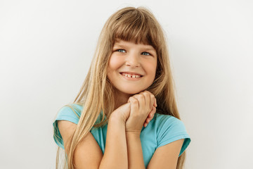 Dreamy,pleased, thinking emotion . Wish concept. 9 year girl  face portrait on white backgound.