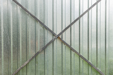 Fragment of the gate from the metal profile. Background