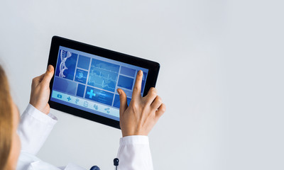 Close of female doctor hands working with tablet pc computer