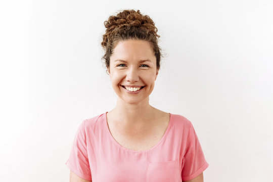 30 years curly woman portrait against white background. Laughter and joy emotions