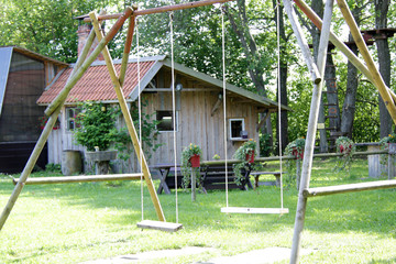 children background with wooden swing and house on background