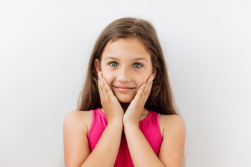 Fototapeta premium Surprised,shock ,unbelievable emotion. 9 year girl face portrait agaist white backgraund.