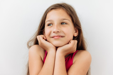 Dreamy,pleased, thinking emotion . Wish concept. 9 year girl face portrait on white backgound.