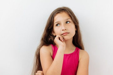 Fototapeta premium Thoughtful, thinking emotion concept. 9 year girl face portrait on white backgound.