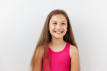 9 year girl portrait against white background. Laughter and joy amotions