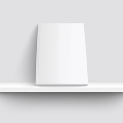 Blank white magazine mockup on bookshelf, empty brochure cover with multiple paper pages leaning against a wall