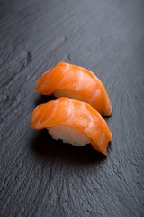 Salmon sushi on a black