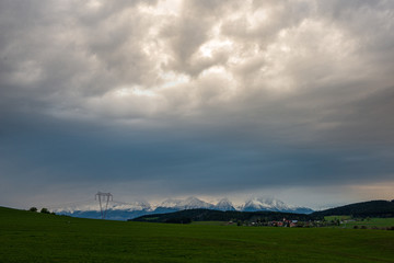 countryside landscape under blue sky and dramatic white clouds