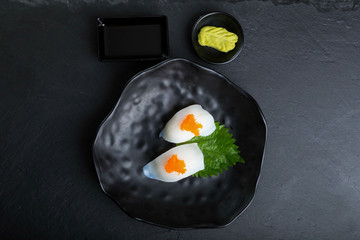 Creative Japanese food menu,
Squid sushi named Ika.Sprinkled with orange salmon roe