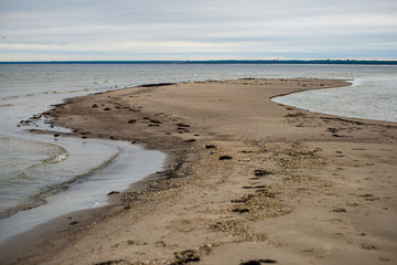 windy sea beach with white sand and blue water