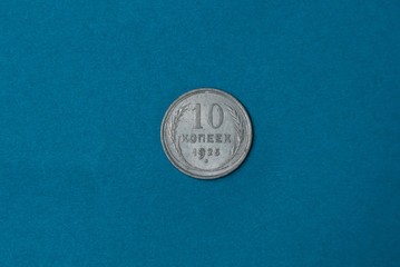 one old silver soviet coin lies on a blue table