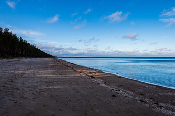 windy sea beach with white sand and blue water