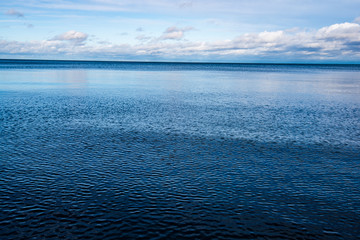 windy sea beach with white sand and blue water