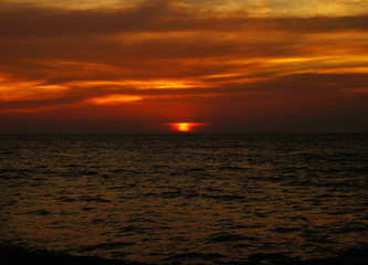 Bright contrast saturated sunset on the ocean on the southern tropical coast.
