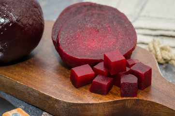 Sliced cooked beetroot on a wooden board