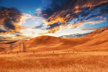 view of dry farmland at sunset - obrazy, fototapety, plakaty