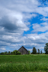 countryside landscape under blue sky and dramatic white clouds