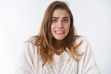 Girl smell problems feeling awkward worried silly insecure female trainee making mistake saying oops unwilling face consequences clenching teeth awkward smile frowning intense stooping shrugging