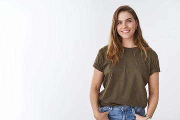 Attractive modern young urban woman chestnut short haircut wearing olive t-shirt holding hands pockets smiling friendly relaxed sound-minded pose, outgoing woman communicating grinning - 272159854