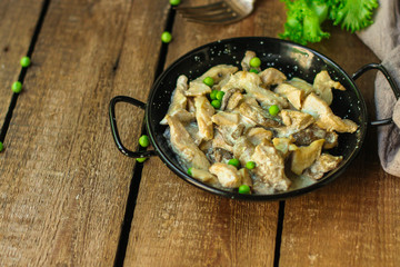 chicken with mushrooms in a creamy sauce - snacks. healthy food and menu. copy space