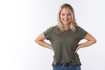 Excited assured blond woman in t-shirt eager start project looking confident and cheeky holding...