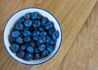 Blueberrys from above agaisnt a wood background